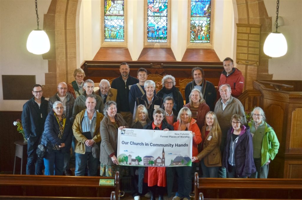 Community groups at the Bedrule Chruch holding a sign: ''Our Church in Community Hands''
